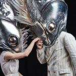 dancers in giant fish heads